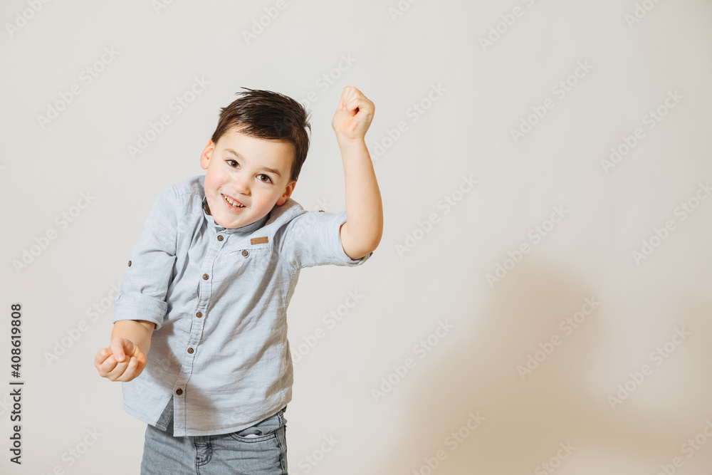 5 year old boy is having fun. Boy points forward with his hand. Boy shows emotions 5 year old boy is having fun. Boy points forward with his hand. Boy shows emotions