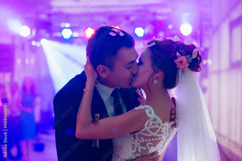 The groom kisses the bride during the first dance. Very tender moment. The groom kisses the bride during the first dance. Very tender moment.