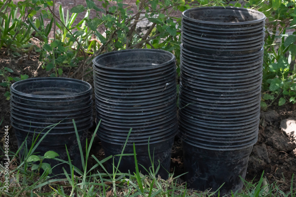 Plastic pot line up. Empty black flower pots. Plastic pot line up. Empty black flower pots.