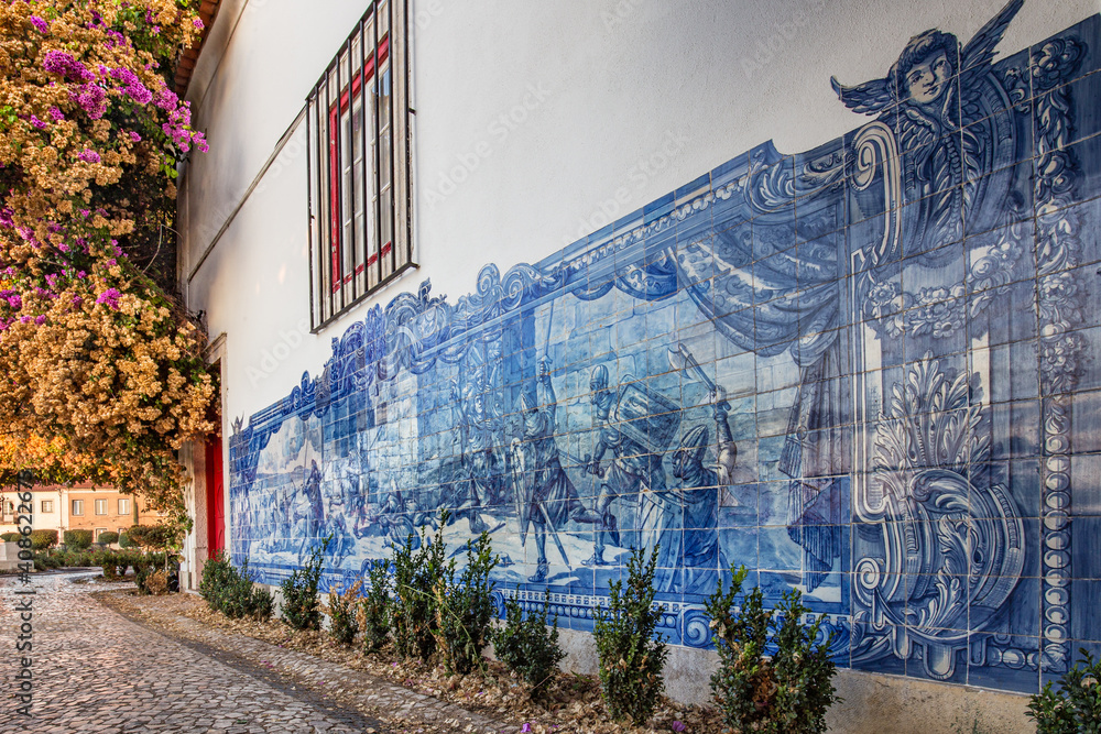 Fototapeta premium A wall of a traditional Portuguese house in Lisbon decorated by blue azulejo tiles showing the battle scene. No people