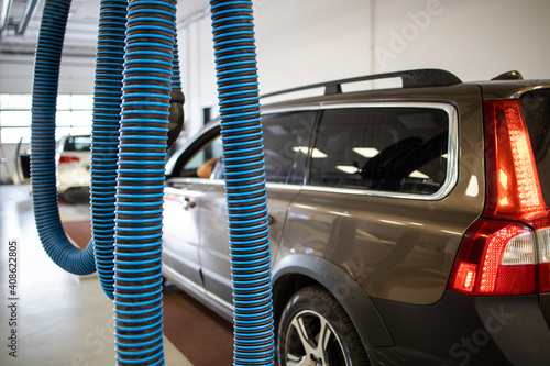 Car in a modern garage being worked on (shallow DOF/color toned image) photo