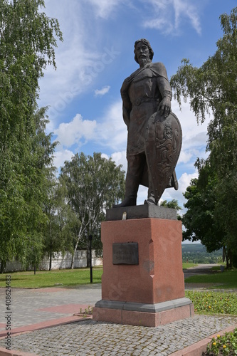 Monument to prince Alexander Nevskiy, prominent figure in Russian medieval history. Green summer trees are around. The 