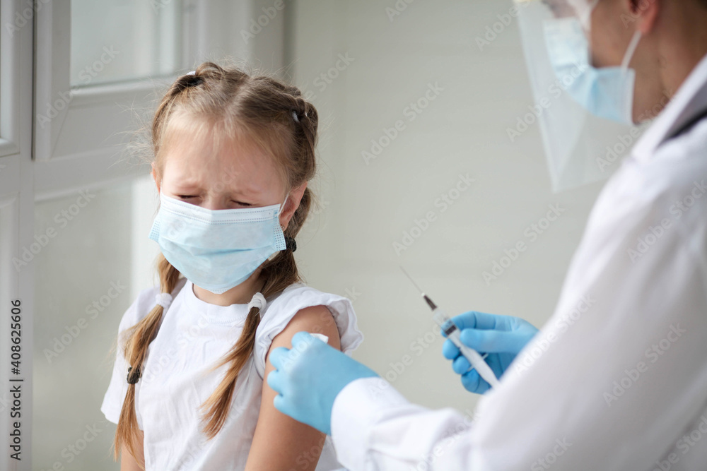 The little girl is crying, afraid of the injection. Vaccination against coronavirus. COVID-19 vaccine. The little girl is crying, afraid of the injection. Vaccination against coronavirus. COVID-19 vaccine.