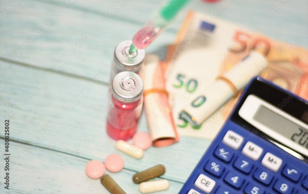 medicine bottles, euro bills and calculator medicine bottles, euro bills and calculator