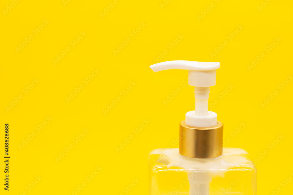 Plastic white bottles with dispenser pumps isolated on yellow background. spa concept Plastic white bottles with dispenser pumps isolated on yellow background. spa concept