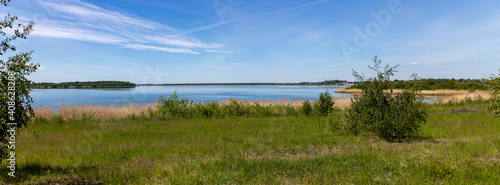 Panorama of renaturized brown coal open pit landscape with the lake Grosser Goitzschesee near the town of Bitterfeld, Germany, Europe