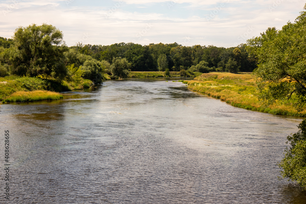 View of healthy nature on the river Mulde taken from the Mulderadweg cycle path near the city of Dessau, Germany, Europe b