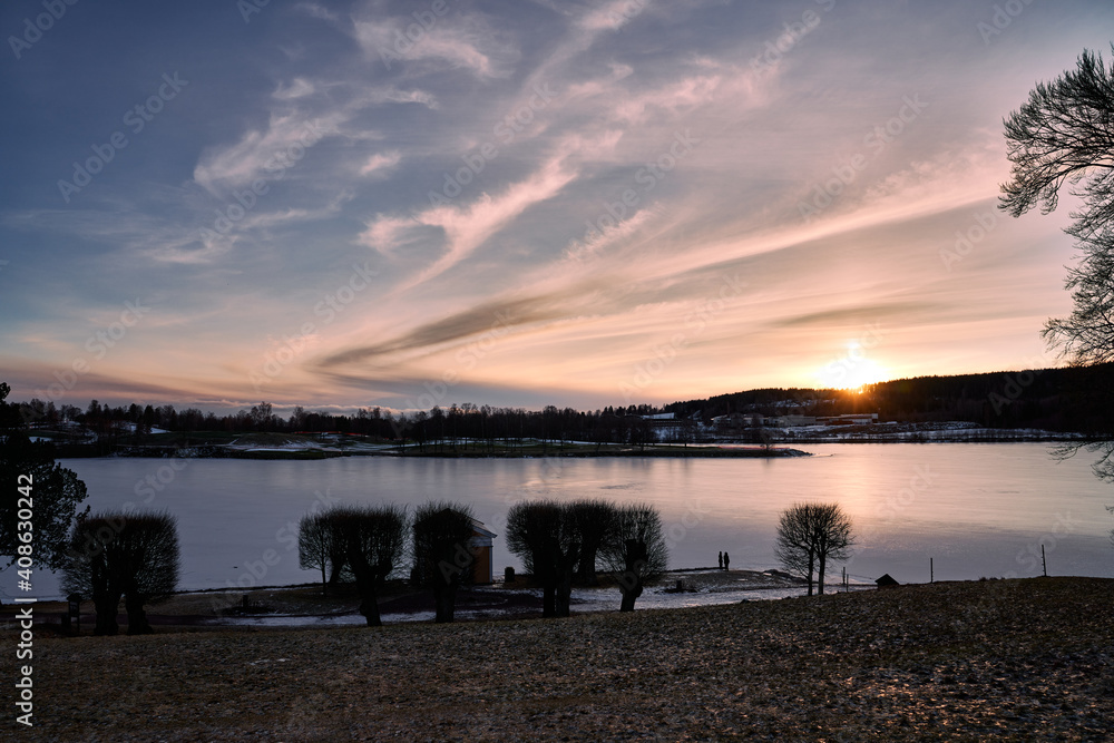 Fototapeta premium Sunset at the local lake outside of Oslo. Bogstadvannet in Nordmarka or Oslomarka it is called. This is a popular lake for fishing, skating and winter activities. 