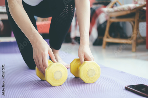 Closeup woman hands holding dumbell. photo