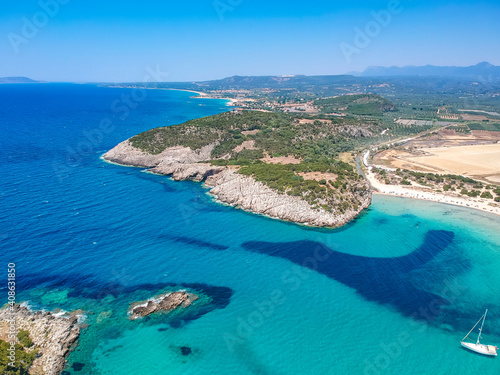 Aerial panorama view of the famous semicircular sandy beach and lagoon of Voidokilia in Messenia, Greece © panosk18