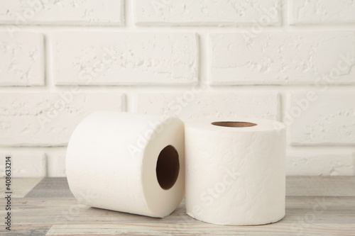 Roll of toilet paper on light background, top view. Space for text