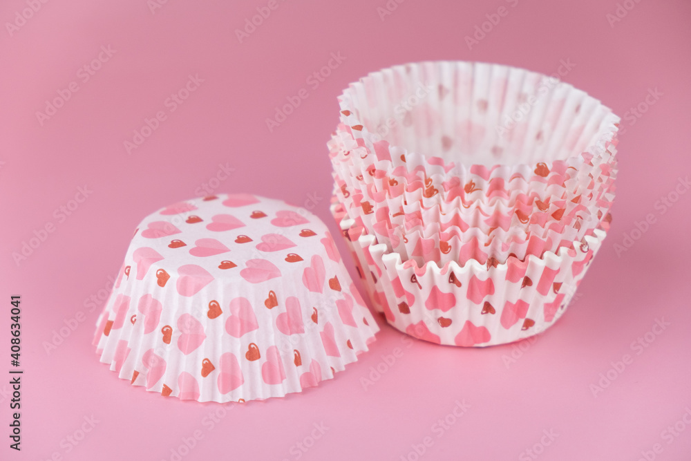 empty pink cupcake mold with hearts on a pink background. Valentine's Day empty pink cupcake mold with hearts on a pink background. Valentine's Day