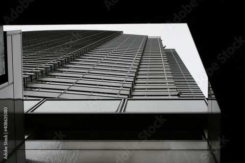 A shot of a skyscrapper taken from the bottom of Tokyo's Photography Museum photo