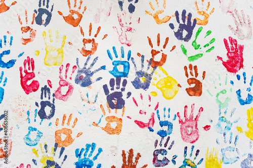 White wall with colorful multicolored hand prints. © Mazur Travel