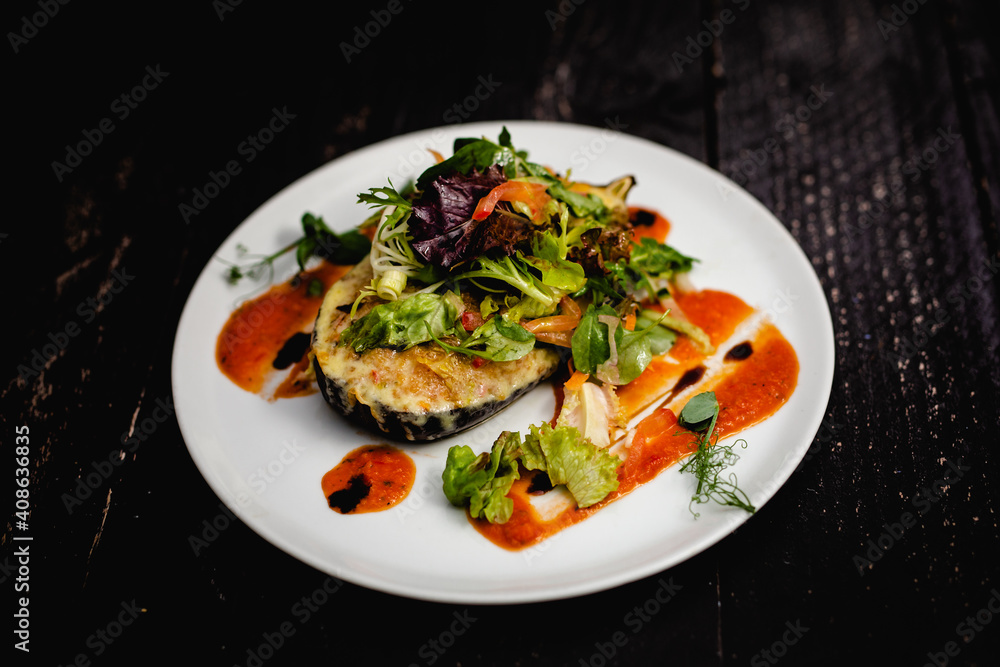 Couscous stuffed, baked aubergine topped with cheddar, served with a dressed baby leaf salad Couscous stuffed, baked aubergine topped with cheddar, served with a dressed baby leaf salad