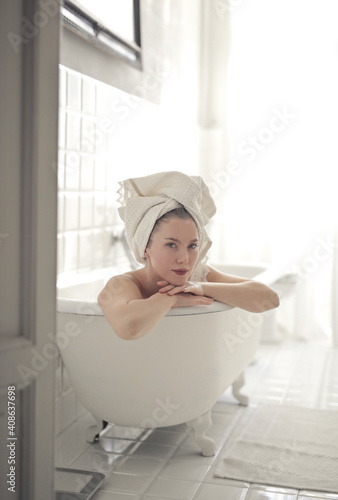relaxed young woman in bathtub