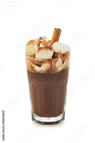 Glass of hot chocolate with marshmallow and cinnamon stick on white