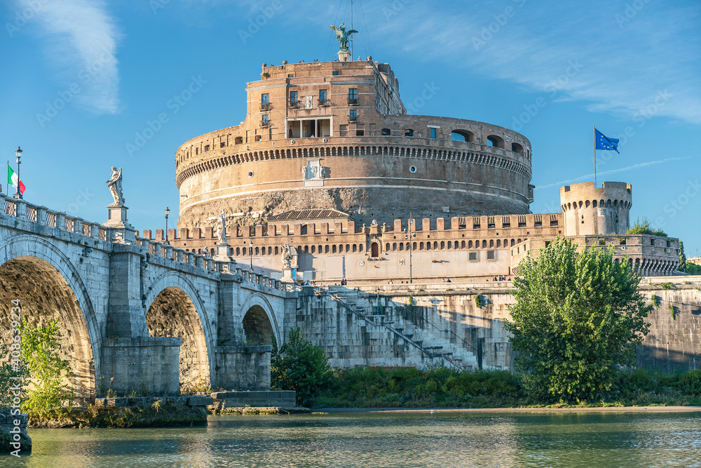 Rome, Italy - October 9, 2019 - View of the old bridge, sculptures of angels and the Castel Sant'Angelo against the blue sky