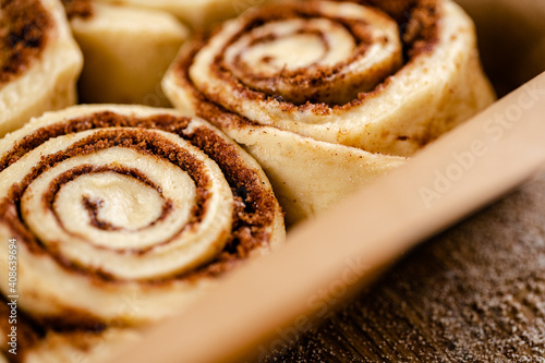 Raw cinnamon roll dough being prepared ready for baking