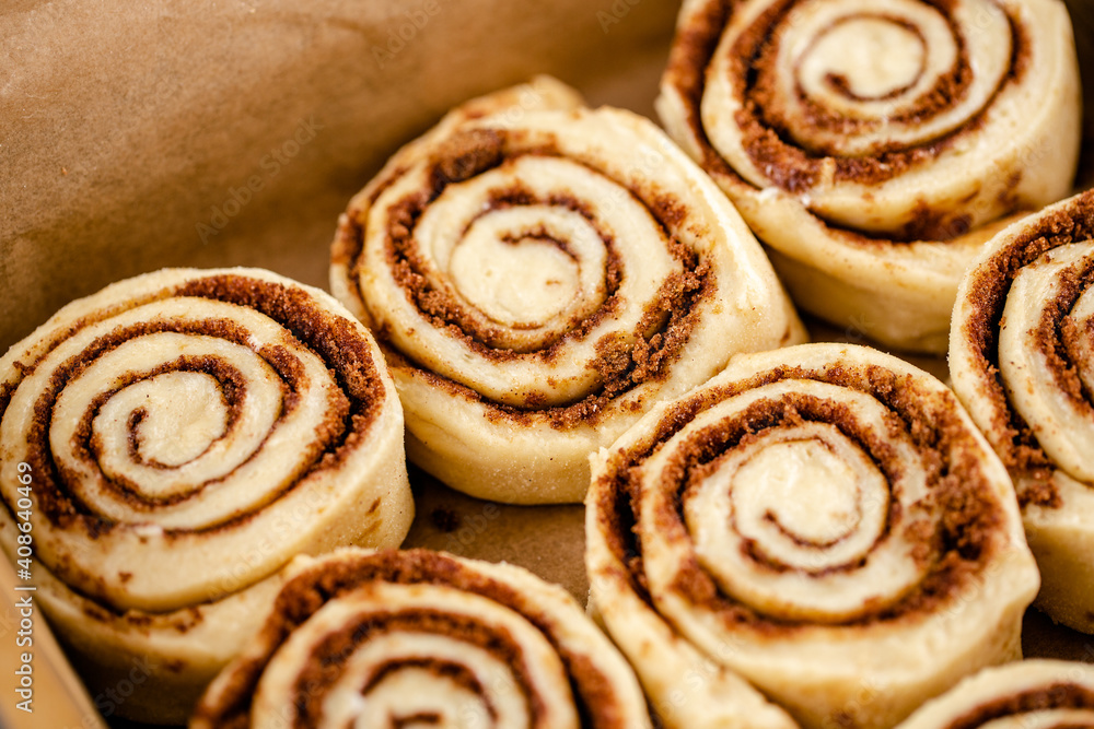 Raw cinnamon roll dough being prepared ready for baking Raw cinnamon roll dough being prepared ready for baking