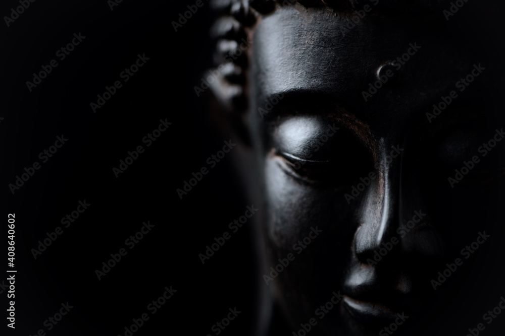 Meditating Buddha Statue isolated on black background. Copy space. Stock  Photo | Adobe Stock