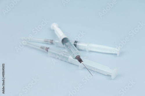 Syringes with different medicines in yellow  red  orange and transparent colors lie on a blue background. The medicine. Vaccine. Covid 19. Coronovirus. An injection. Drugs. The close plan. Top view.