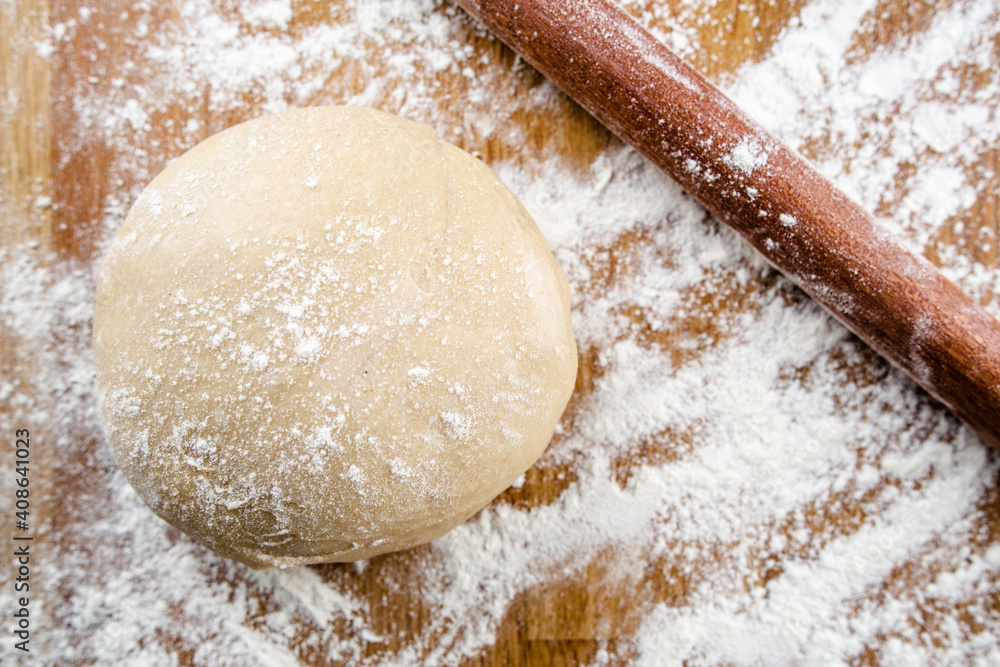 flour and rolling pin with sweet dough flour and rolling pin with sweet dough