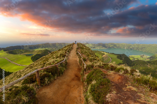 
a man takes a photo from the top of the Grota do Inferno viewpoint. Sete cidades. Sao Miguel. Azores. Portugal