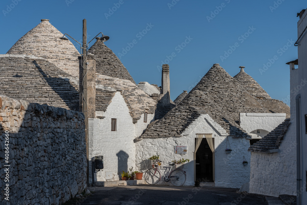 Sunshine on summer vacation in trulli town of Alberobello in Puglia, Italy