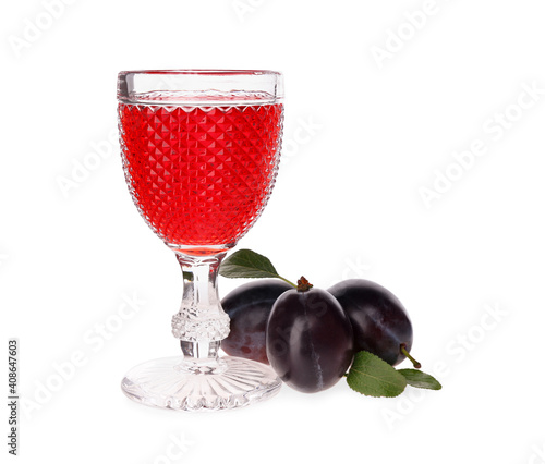 Delicious plum liquor and ripe fruits on white background. Homemade strong alcoholic beverage photo