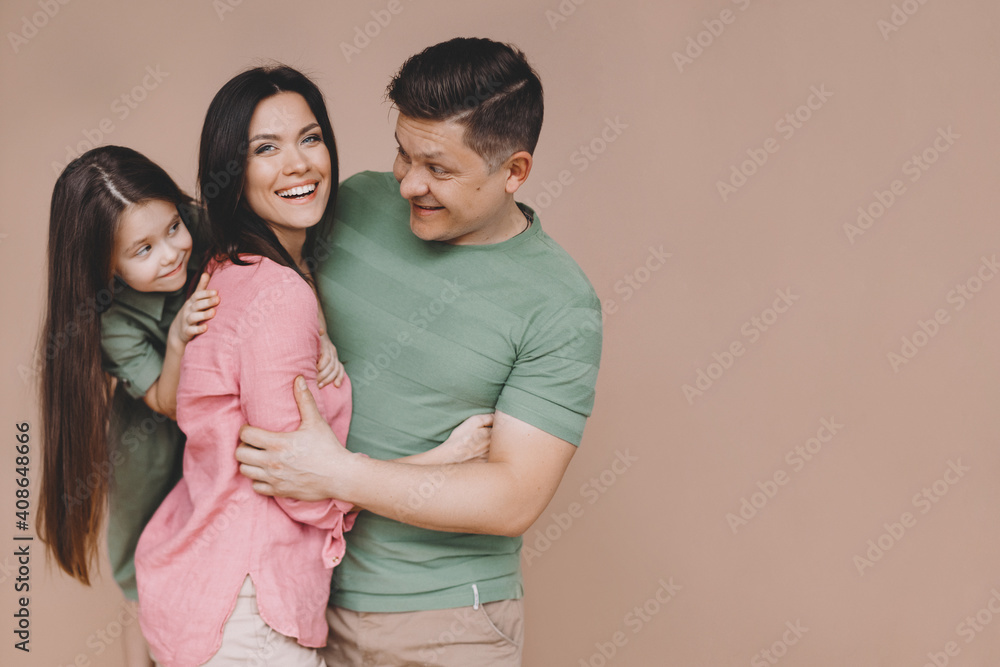 Fototapeta premium Parents with daughter hugging