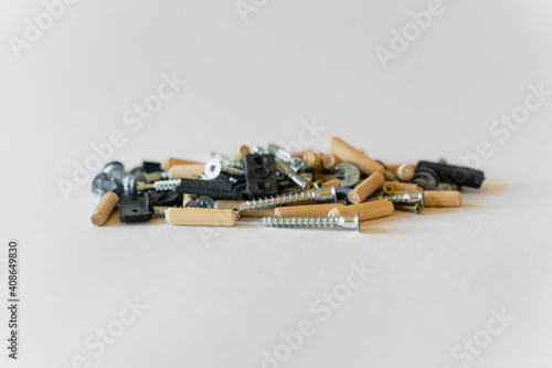 On a white background lies a group of building materials - screws, screws and others.