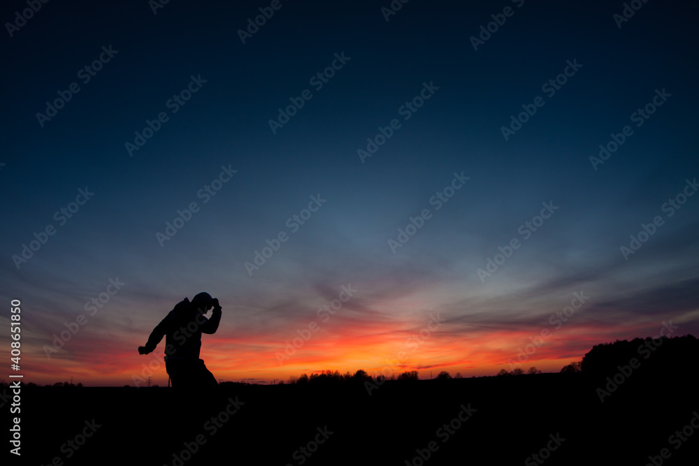 silhouette of a person running on the sunset