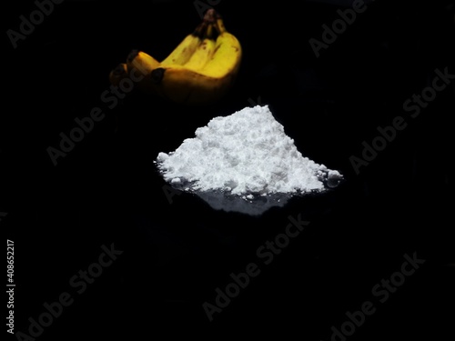 Fotografie Welcome to Colombia - cocaine drug powder and bananas on black background