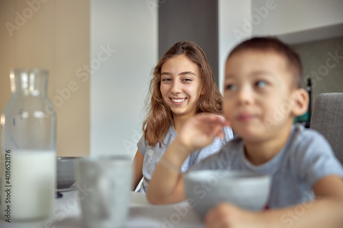 Cheerful happy family is having time at cozy home s dining room