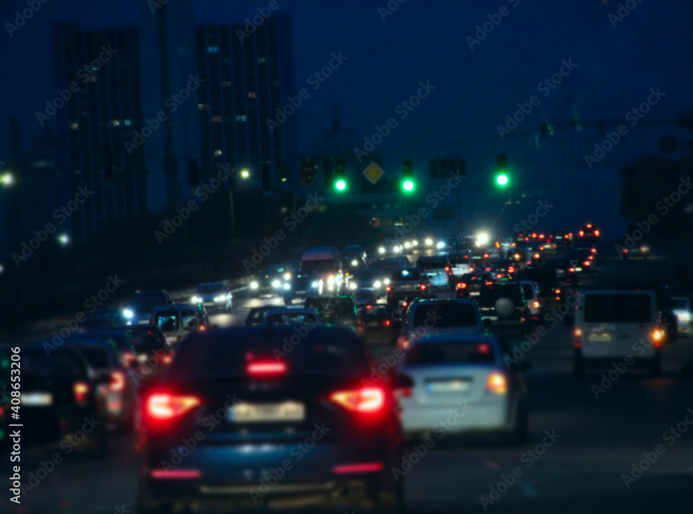 stream of cars in evening traffic jam. Automobiles with headlights stream of cars in evening traffic jam. Automobiles with headlights