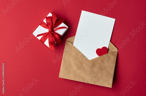 Valentines day card mockup with envelope and gift box with heart on red paper background