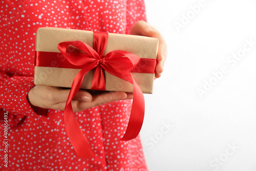 Woman holding gift box on white background, space for text. Valentine's Day celebration