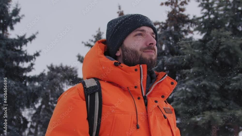 One 30s person adult caucasian man walking towards camera under the pine trees covered in snow One 30s person adult caucasian man walking towards camera under the pine trees covered in snow