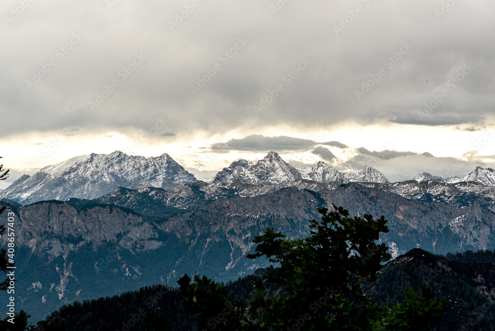 Bavarian Alps on a cloudy day, snowy mountain peaks, gloomy grey sky