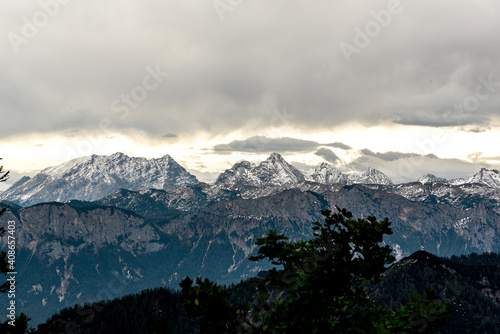 Bavarian Alps on a cloudy day, snowy mountain peaks, gloomy grey sky