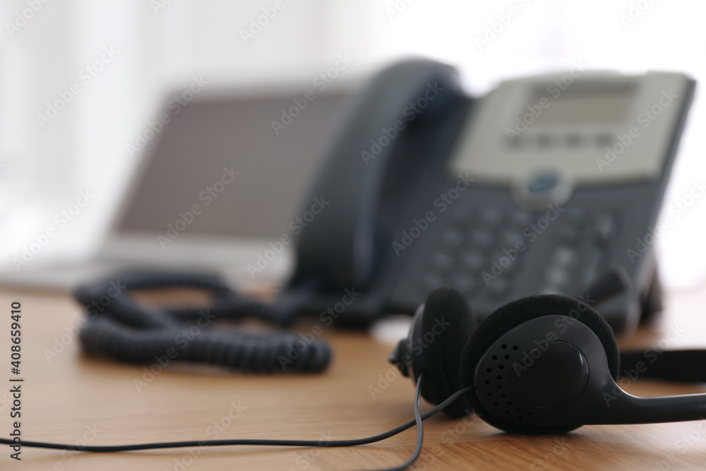 Headset on wooden table indoors, closeup with space for text. Hotline service Headset on wooden table indoors, closeup with space for text. Hotline service