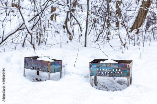Wallpaper Mural Two barbecue facilities or brazier, forgotten in the winter forest on the snow. Picnic, meeting with friends, outdoor charcoal cooking. Backyard picnic area. Torontodigital.ca