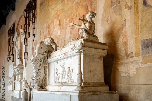 Statues memorialize the dead in the ancient tomb and cemetery of Camposanto Monumentale on the Square of Miracles in the Tuscan city of Pisa, Italy