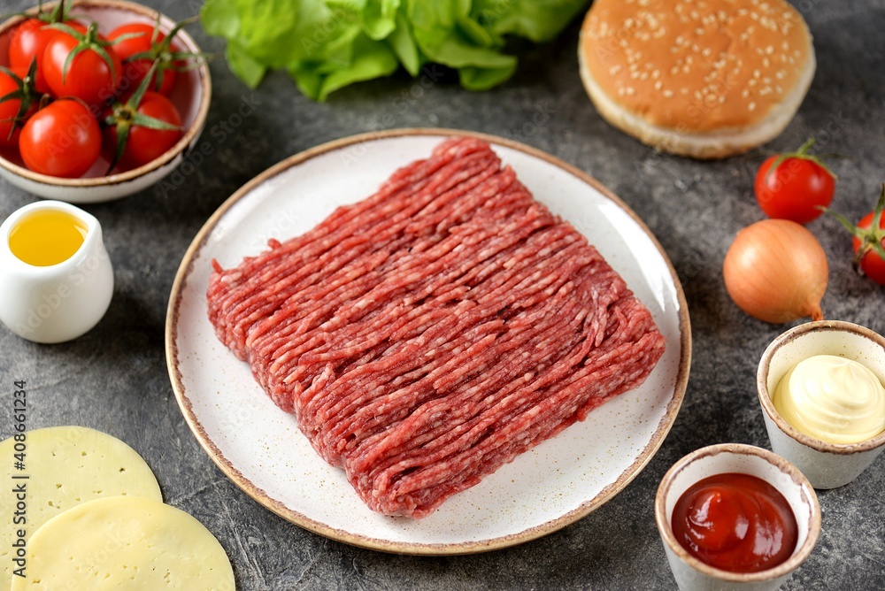 Fresh beef mince and ingredients ready to cook cheeseburgers. Fresh beef mince and ingredients ready to cook cheeseburgers.