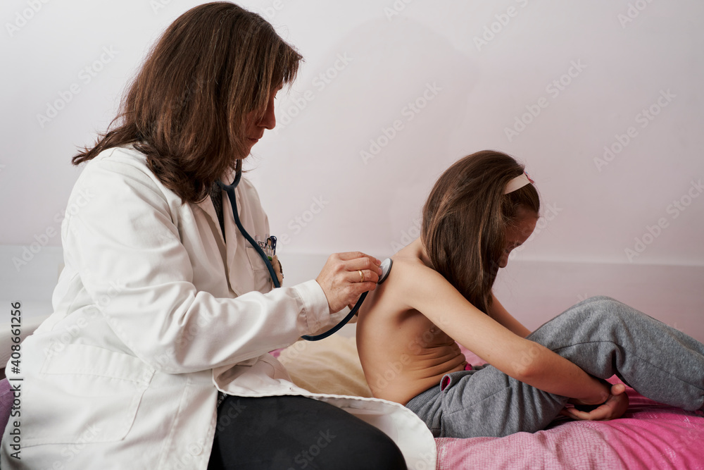Pediatric doctor examine little girl with stethoscope. Child, ca Pediatric doctor examine little girl with stethoscope. Child, ca