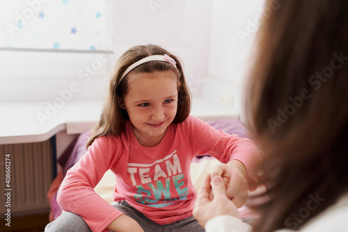 View of a girl looks at the doctor with a smile when she can put