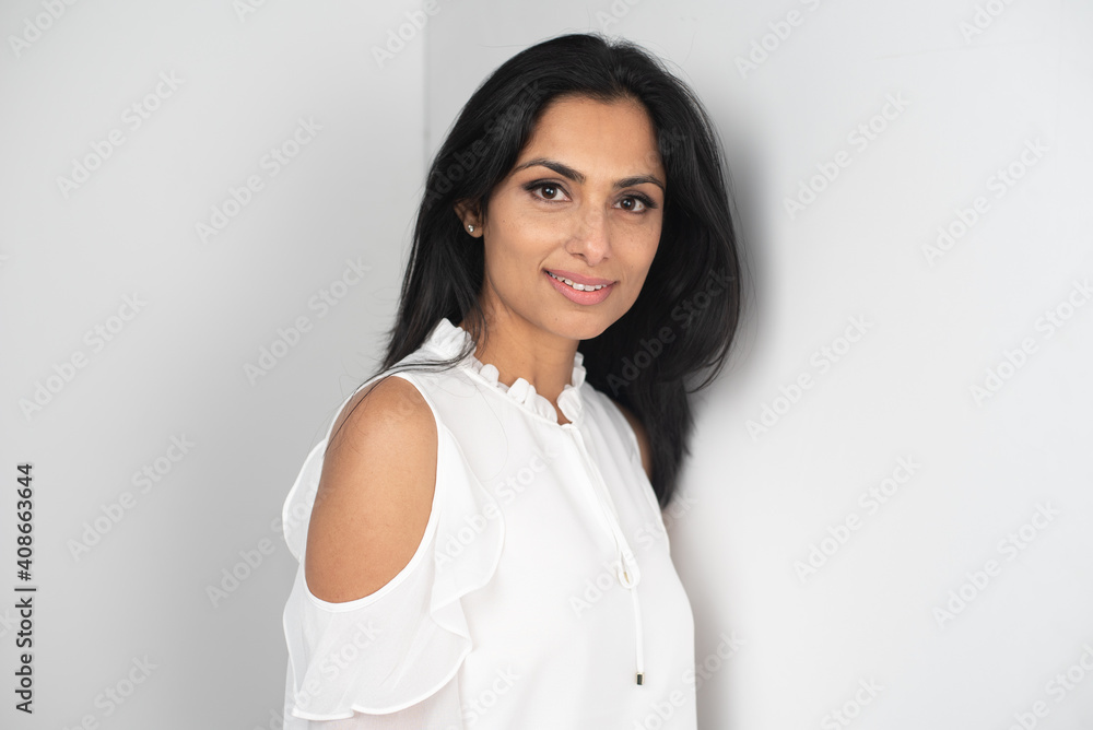 Studio images of beautiful asian Indian woman in blue jeans and white top on white background. Studio images of beautiful asian Indian woman in blue jeans and white top on white background.