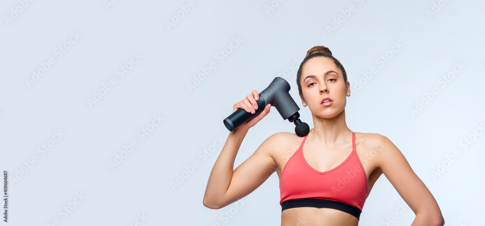 Electric massager gun in hand massages your muscles. Sport recovery concept Electric massager gun in hand massages your muscles. Sport recovery concept