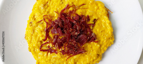 Canvas-taulu Brazilian traditional food, pumpkin rissoto with carne seca, beef jerky, dried b